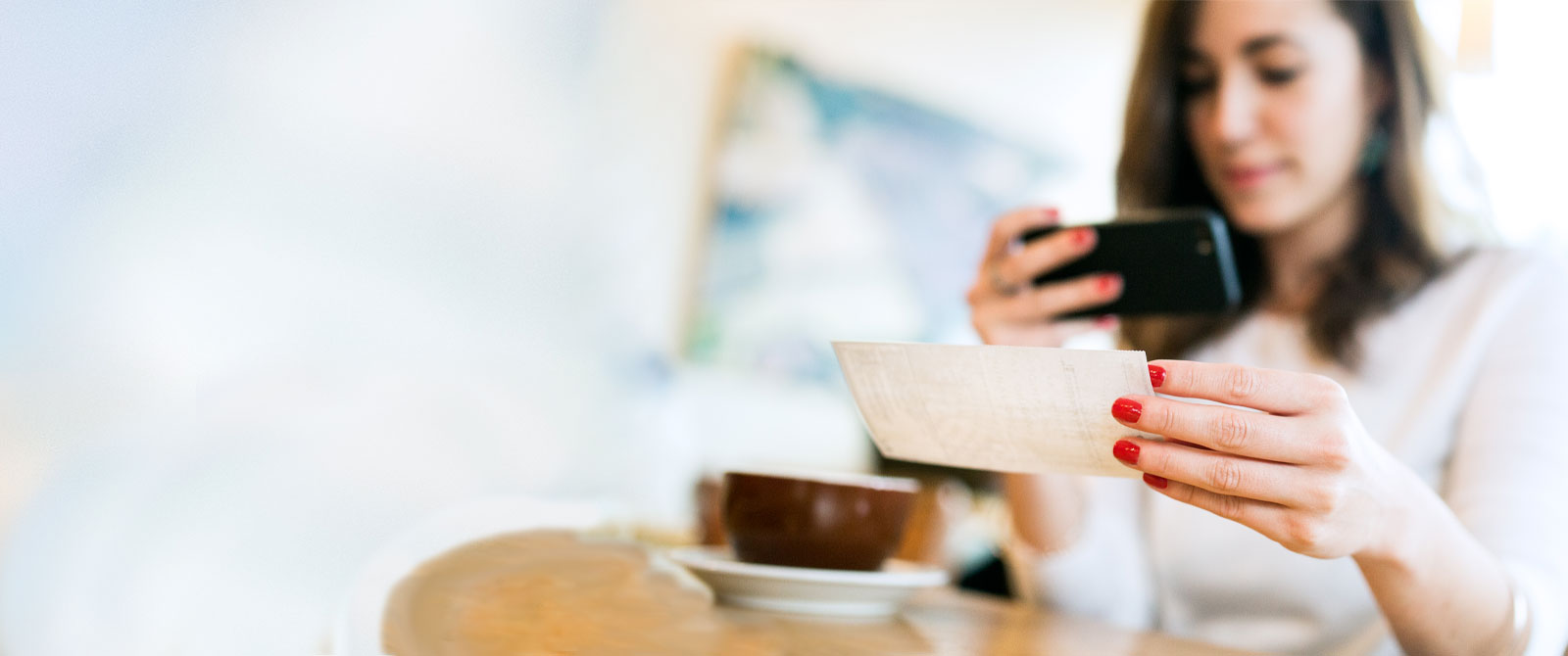 Woman using phone camera to deposit a check